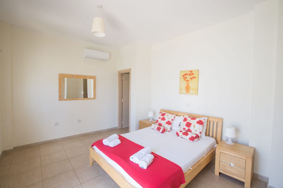 Master Bedroom with en suite bathroom, double bed and balcony access