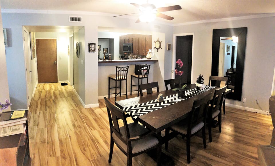 Entrance to condo with kitchen, bar counter and dining area.