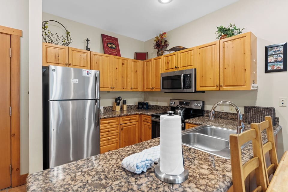 Full kitchen featuring stainless steel appliances.