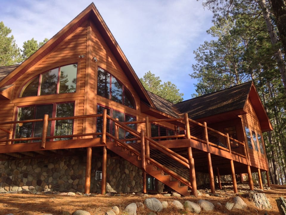 Back of home with access to the deck and 3 season room for relaxing & grilling