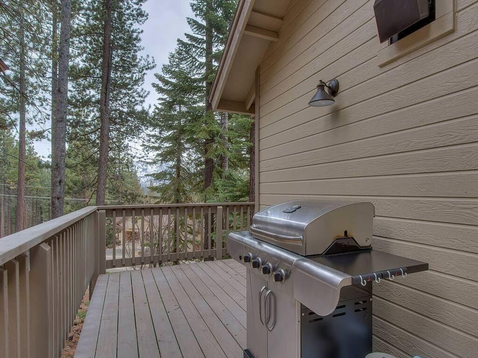 Cozy deck with grill overlooking peaceful forest views