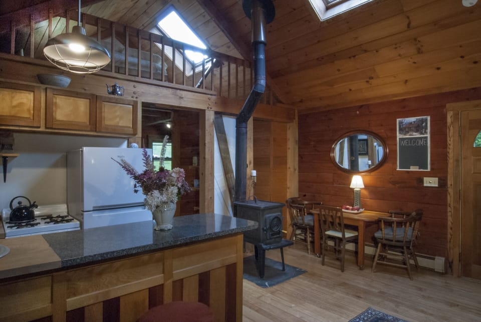 Our dining table seats 4-6 people. Located right next to our woodturning stove.