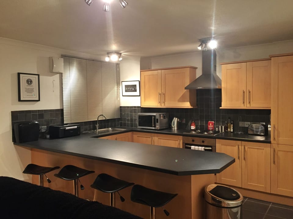 Open plan kitchen with washing machine, dishwasher, microwave, fridge/freezer