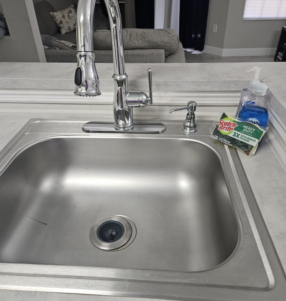 Kitchen sink with fresh sponge.