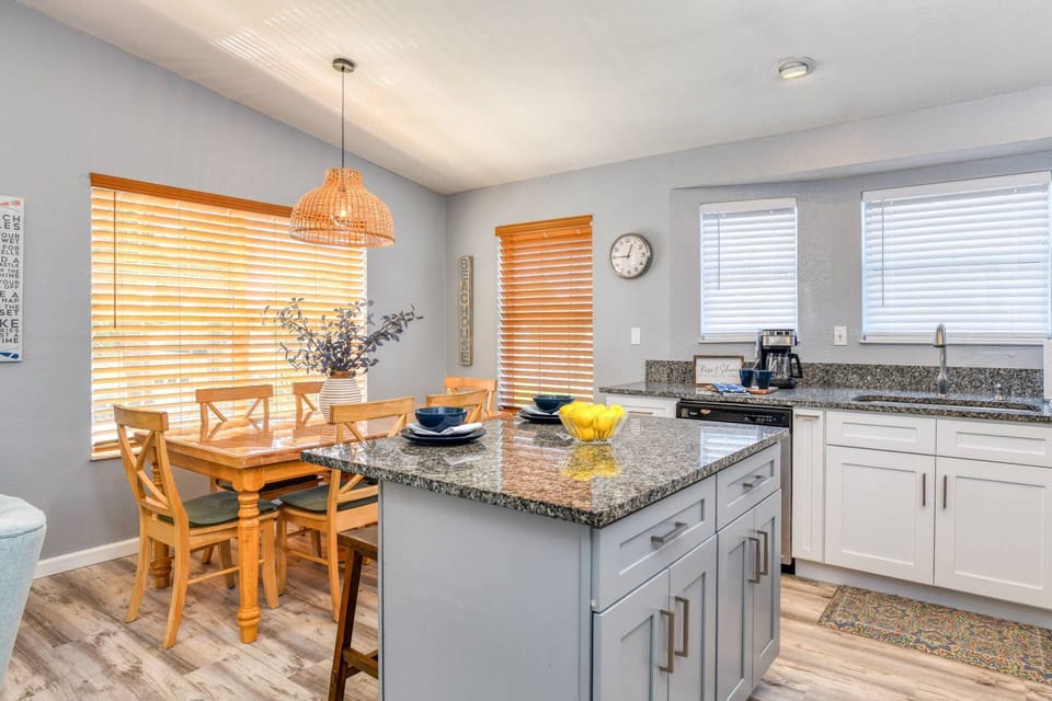 A dining table for six plus breakfast bar island provide ample space for meals and snacks.