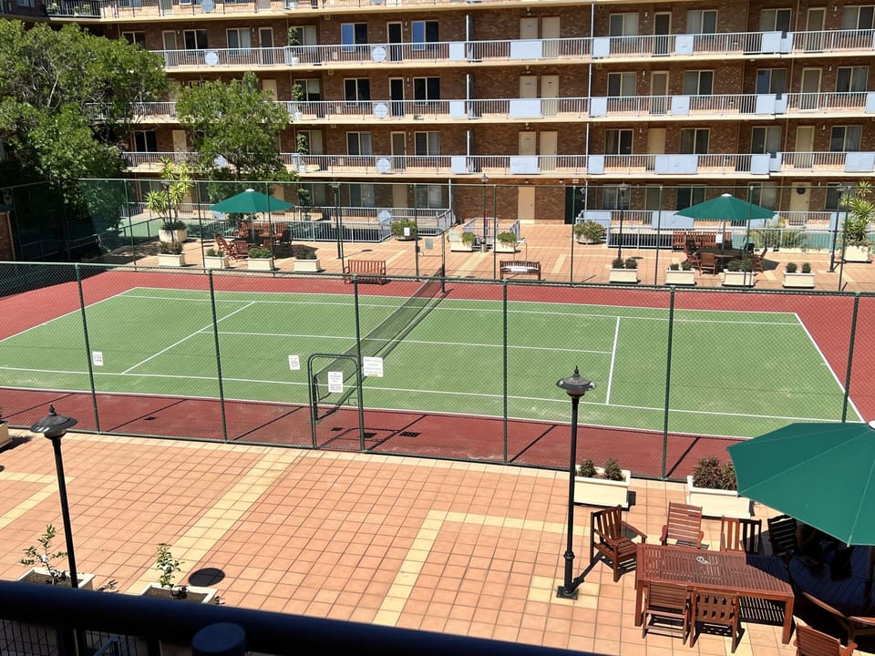 Full tennis court inside property
