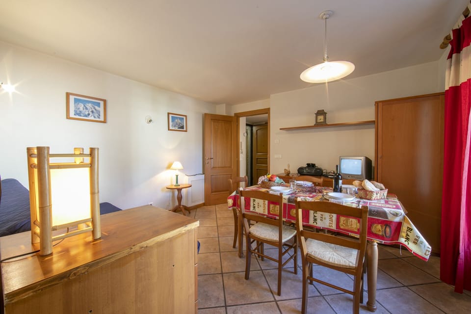 Open plan living room with dining set and adjoining kitchen