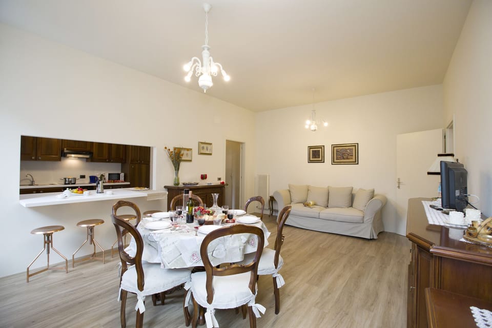 The living room with dinner table, sofa bed and view of the kitchen