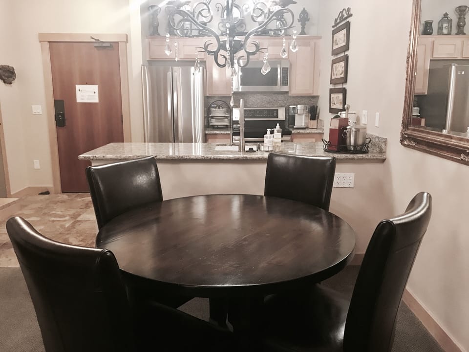 Dining room with leather chairs and crystal Chandelier 