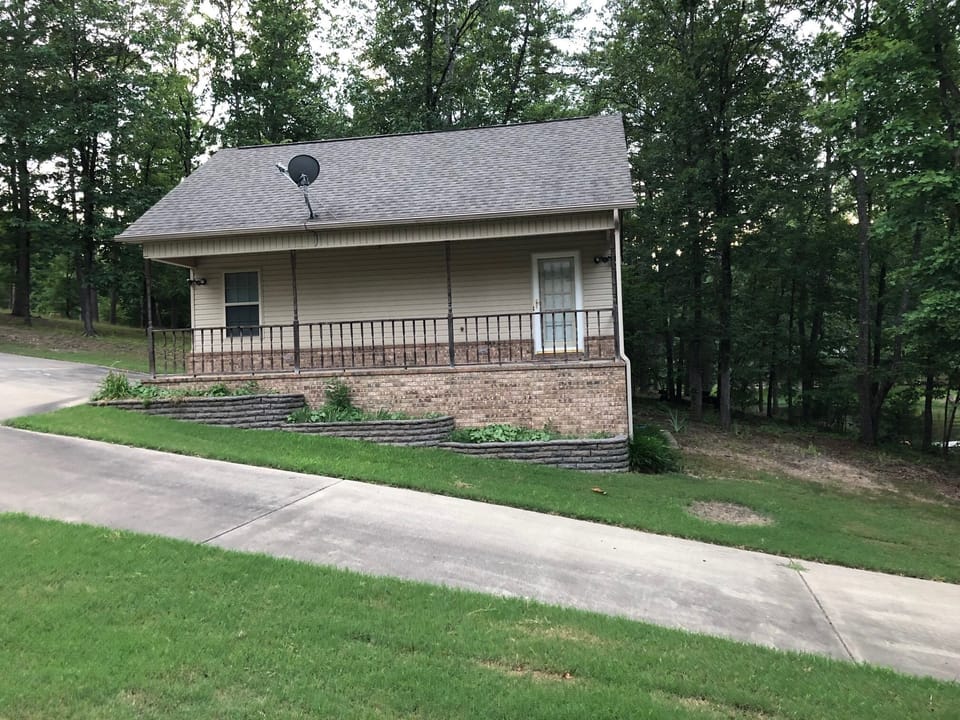 Covered deck and concrete drive to boat ramp and lake access.