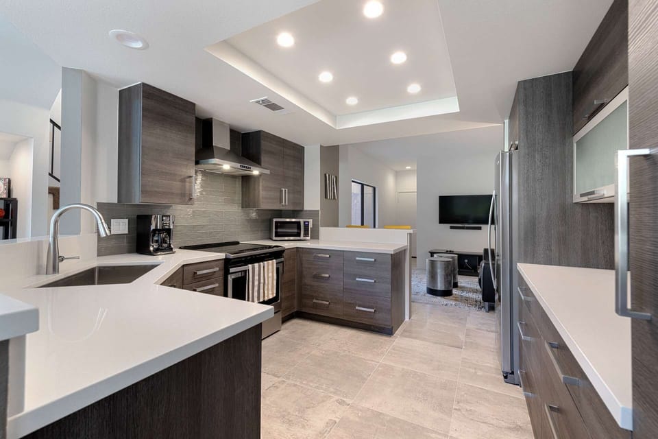 View from kitchen looking into entertainment room with large smart TV