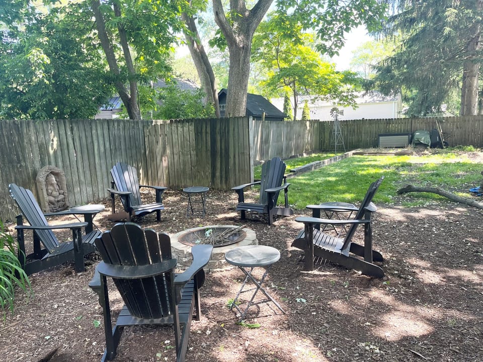 fire pit w black Adirondacks shared among all cottages w side yard for yard game