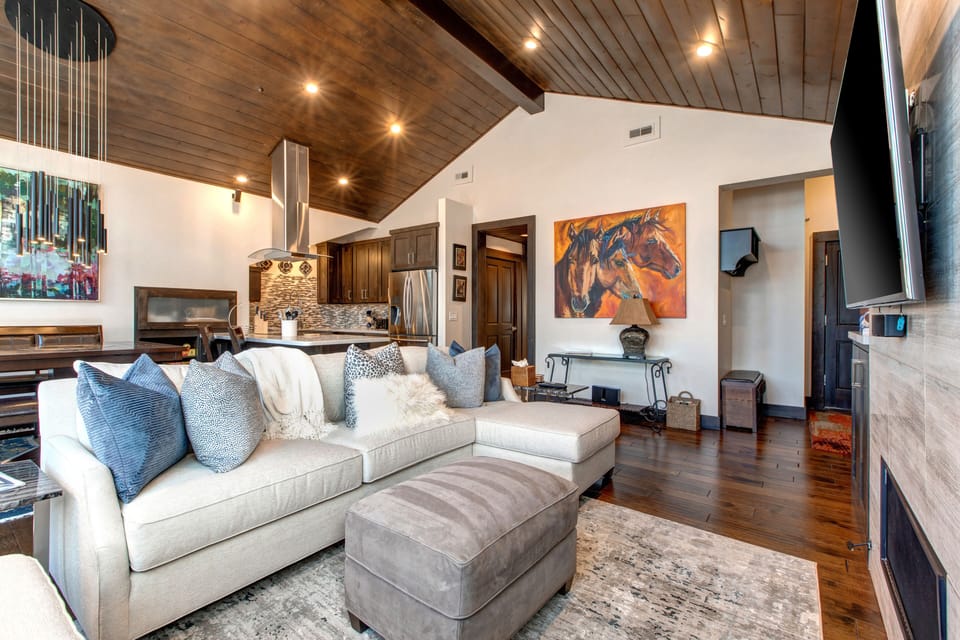 Living Room with Plush Contemporary Furnishings, 55" LG Smart TV, Gas Fireplace, Deck Access with a Private Hot Tub, and Breathtaking Deer Valley Views