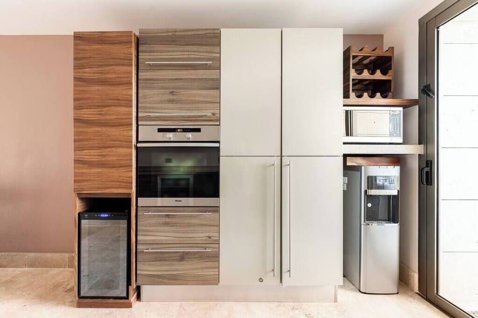 Kitchen Cabinets, Pantry, Water Dispenser, Microwave, and Wine Fridge
