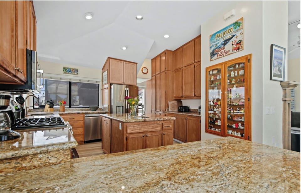 Granite countertops and stainless steel appliances are featured in the kitchen.
