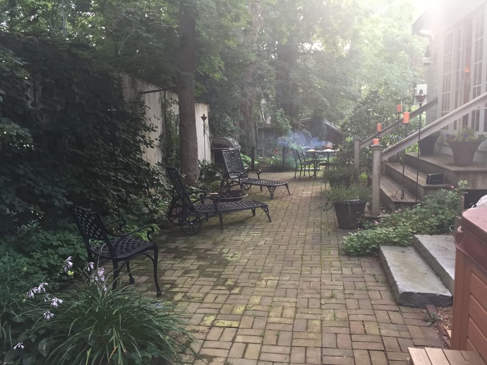 Brick patio with outdoor seating and gas grill.