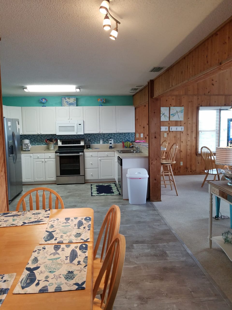 open, fully stocked kitchen with another table. Great for games and puzzles!