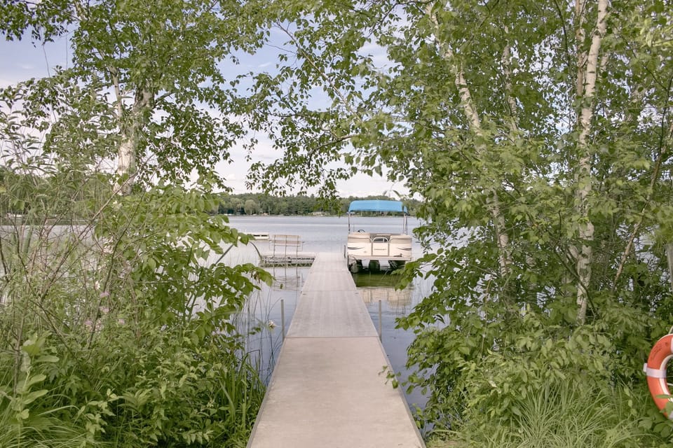 Pontoon boat docked at the pier is available for guest use. 