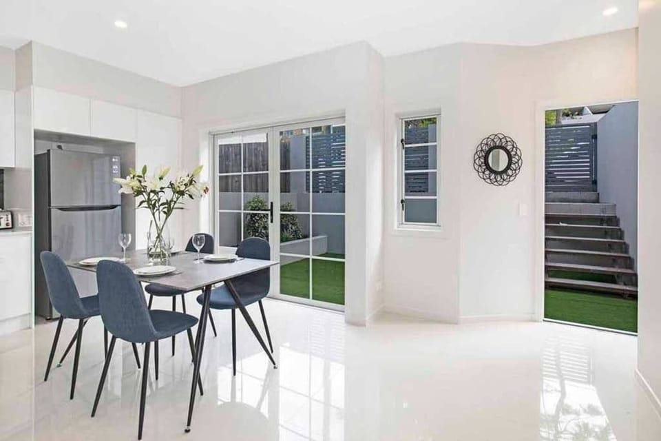 Indoor dining opens to the private courtyard for a brighter ground-floor feel.