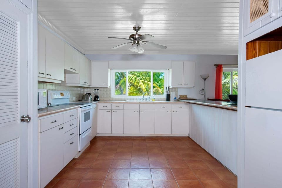 Modern, fully equipped kitchen with ocean views.