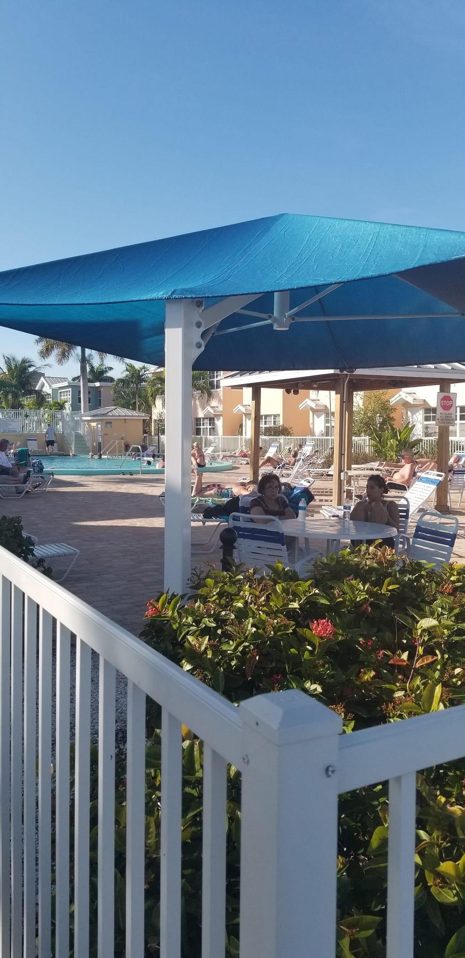 Pool (heated) area with lounge chairs, covered tables, gate code access. 
