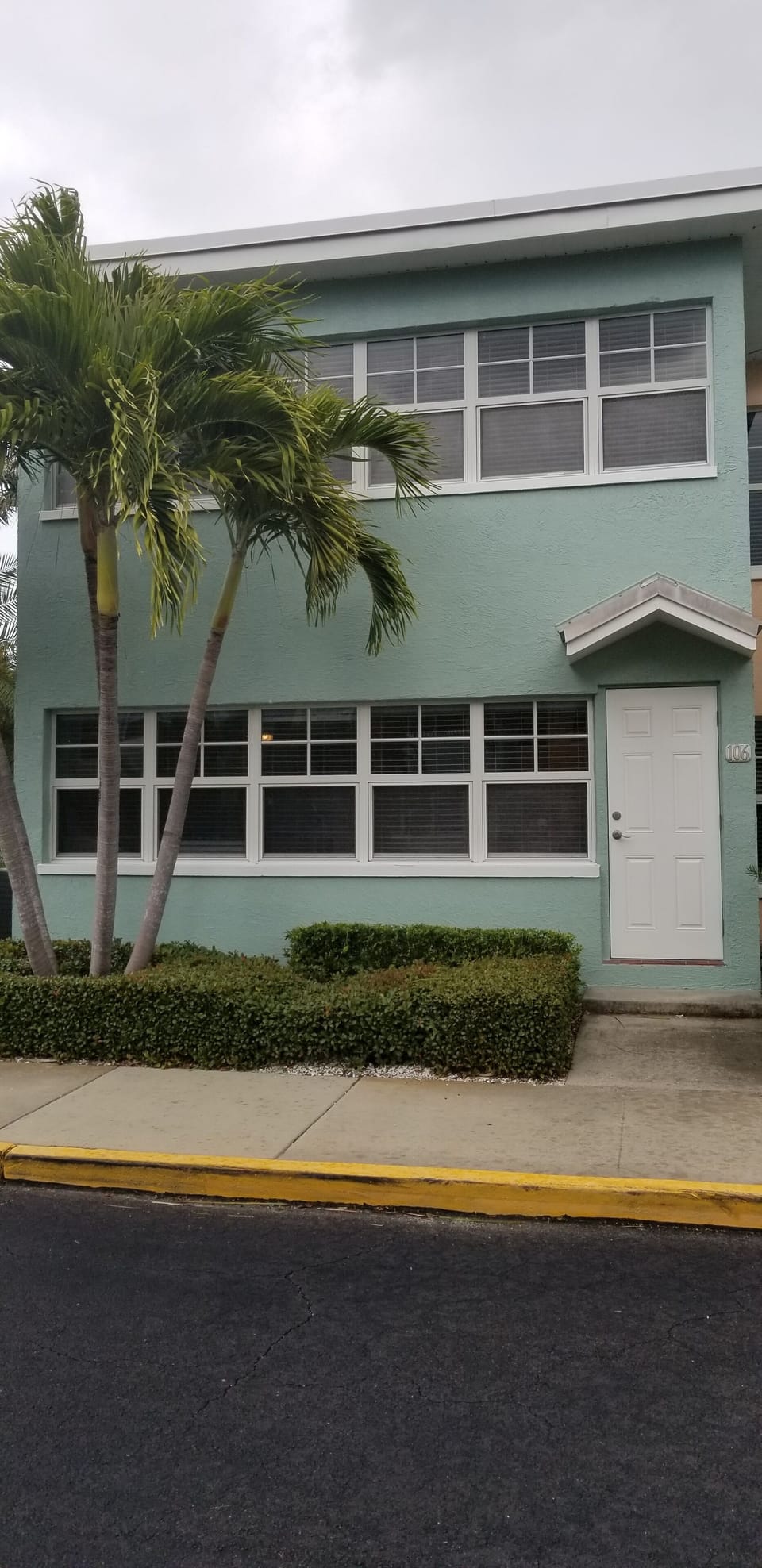 Back door entrance to unit. Sidewalk leading to pool or beach access crosswalk.