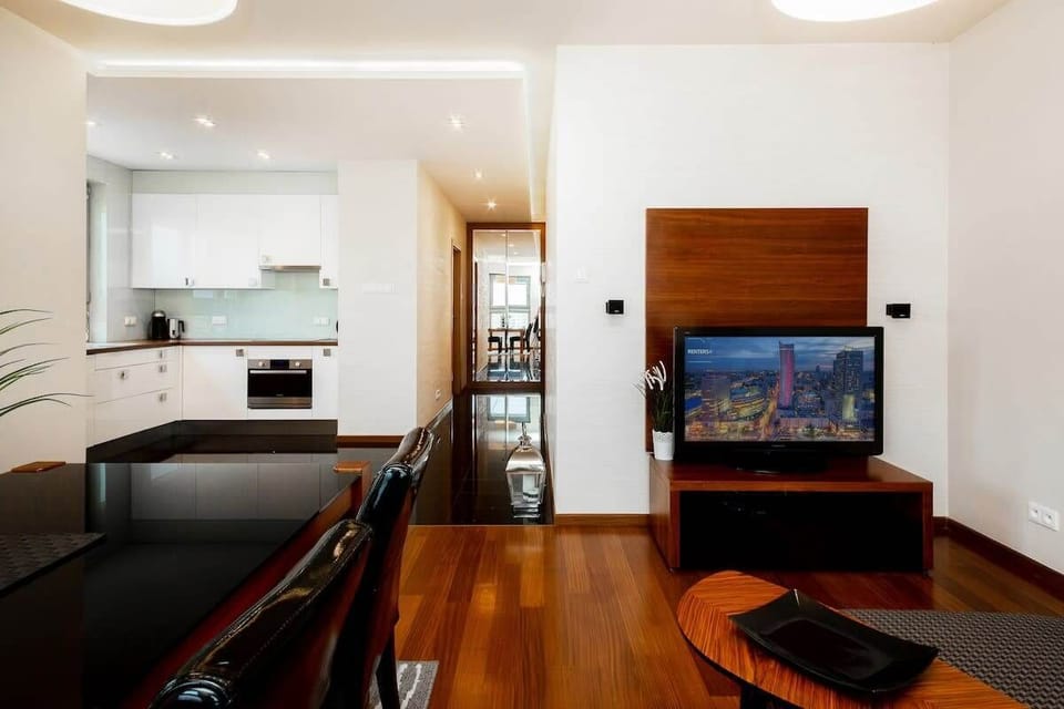 The modern living area is cohesively connected to the kitchenette, Evening entertainment is provided by the available flat-screen TV.