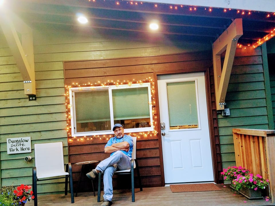 Les Smallwood, my husband, outside the Bungalow suite he built.  Artful living!
