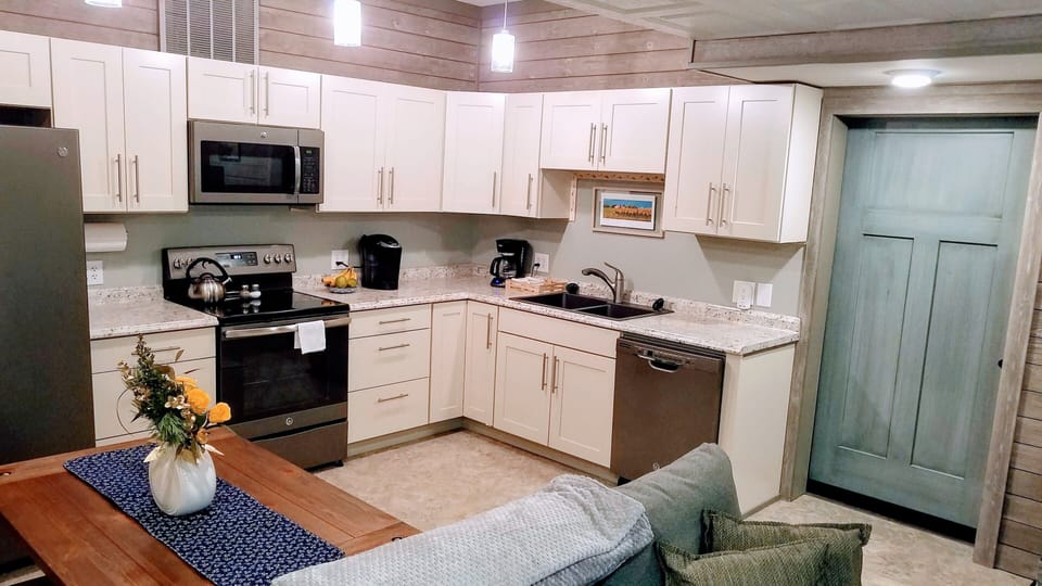 Showing the bedroom barn door and the fully equipped kitchen!  Make meals here!