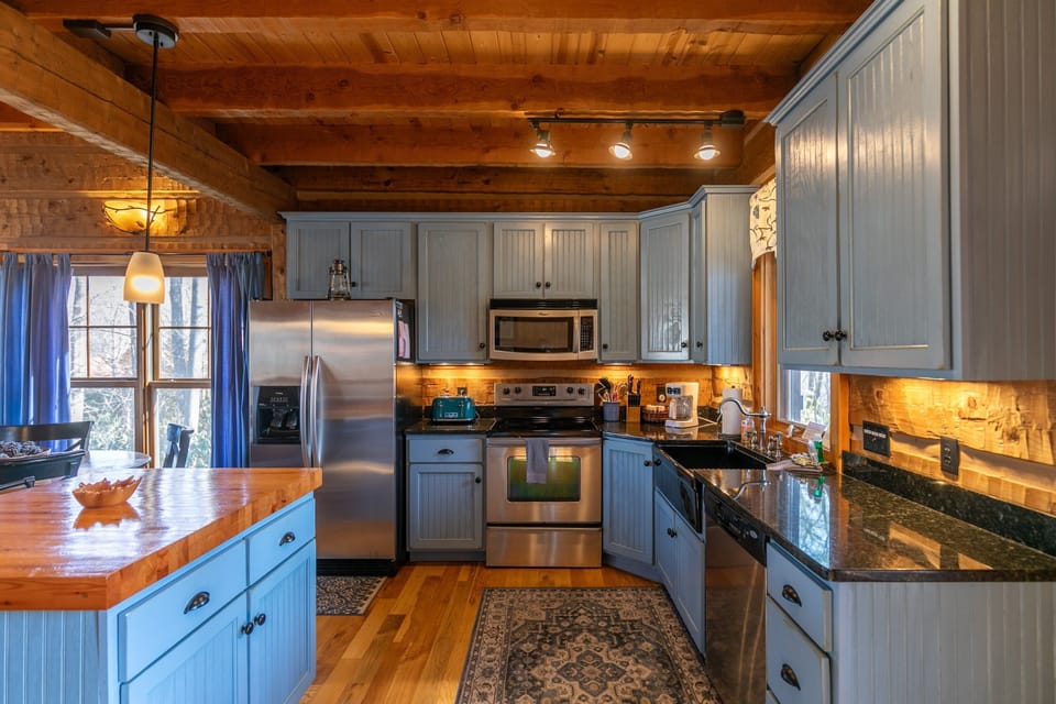 Fully equipped and full of character. The butcher block island and warm timber ceiling make this kitchen a joy to cook in.