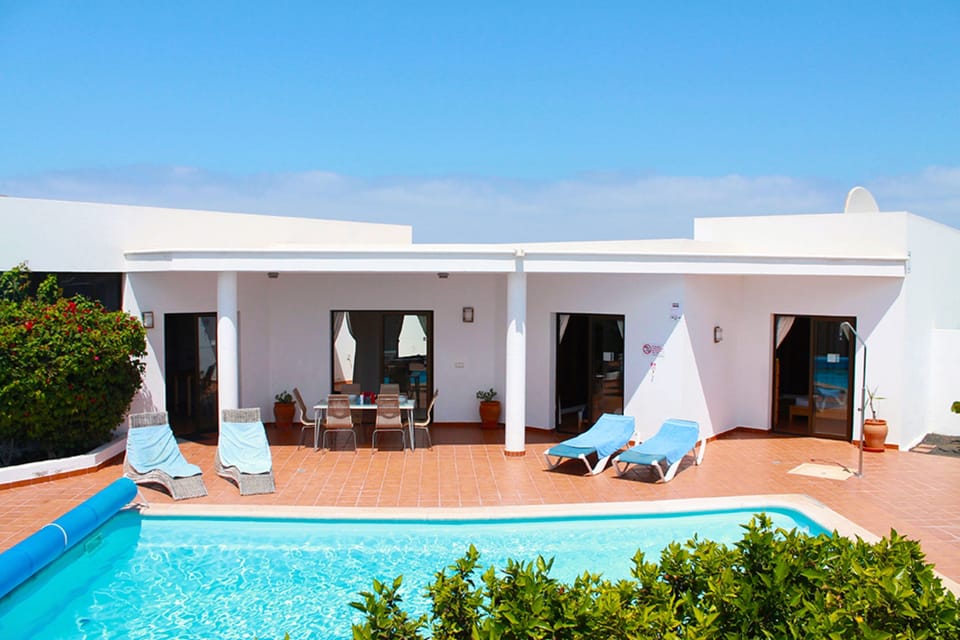 Pool area and terrace under blue skies