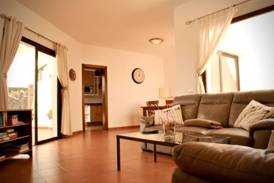 The lounge area leading to the pool area and kitchen
