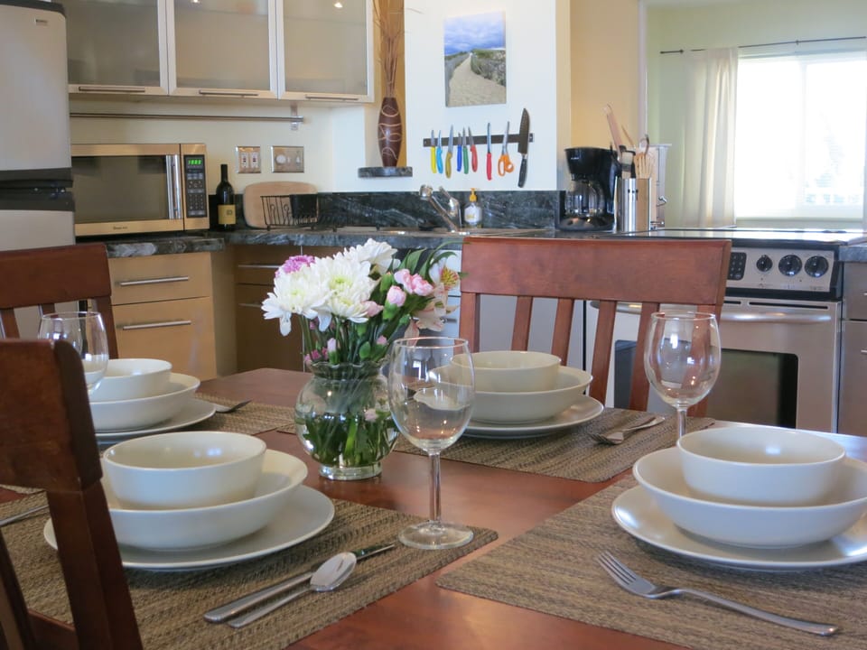 Dining table and stainless steel kitchen.