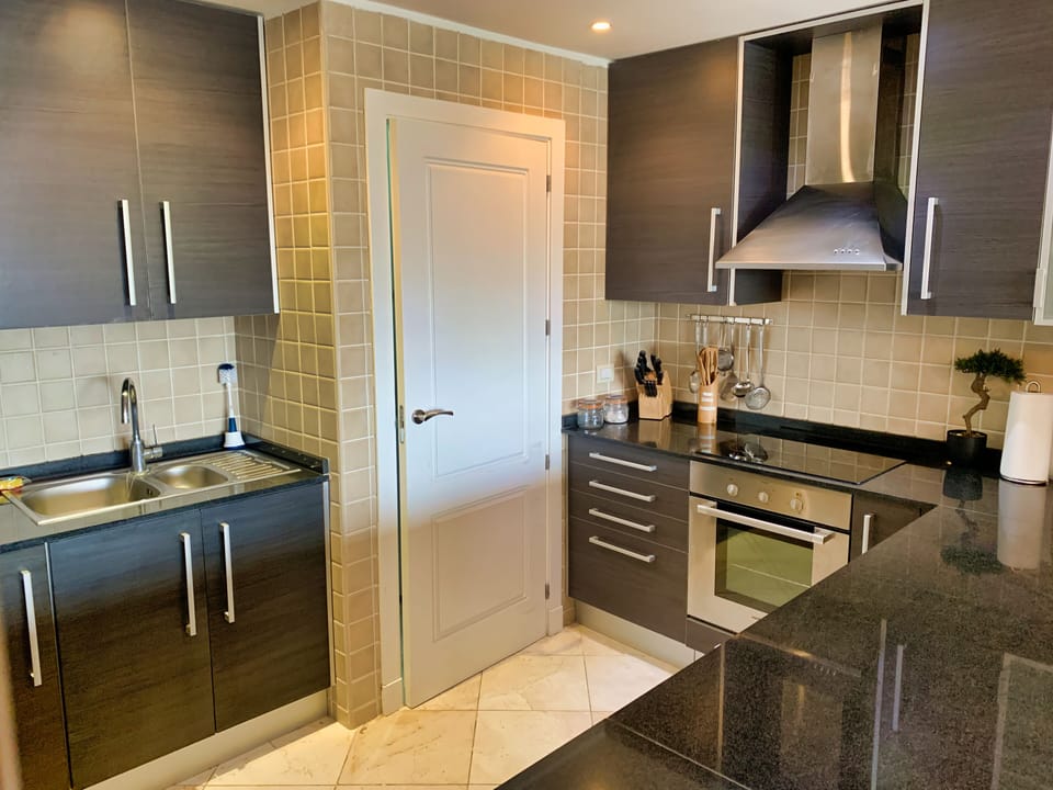 Beautiful well equipped kitchen with black granite countertop