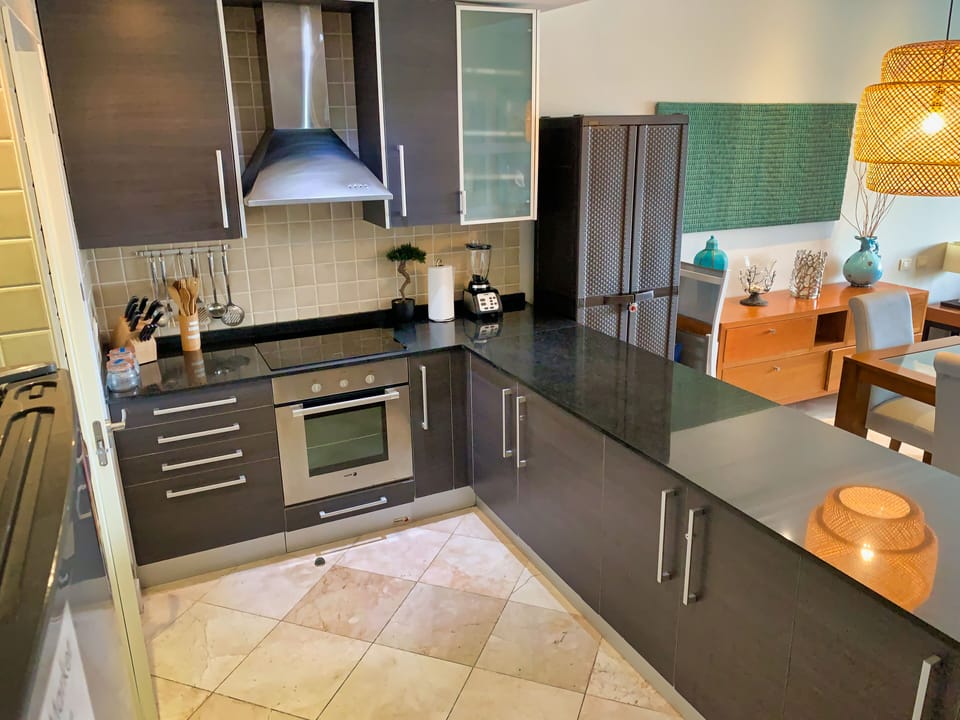 Beautiful well equipped kitchen with black granite countertop