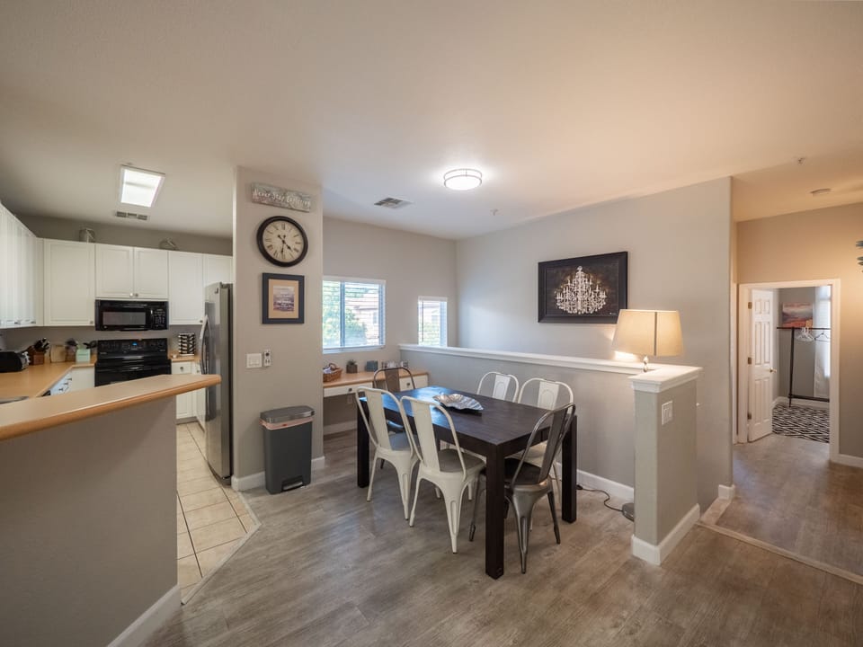 Dining area seats 6 plus barstools at counter. Work desk behind table. 
