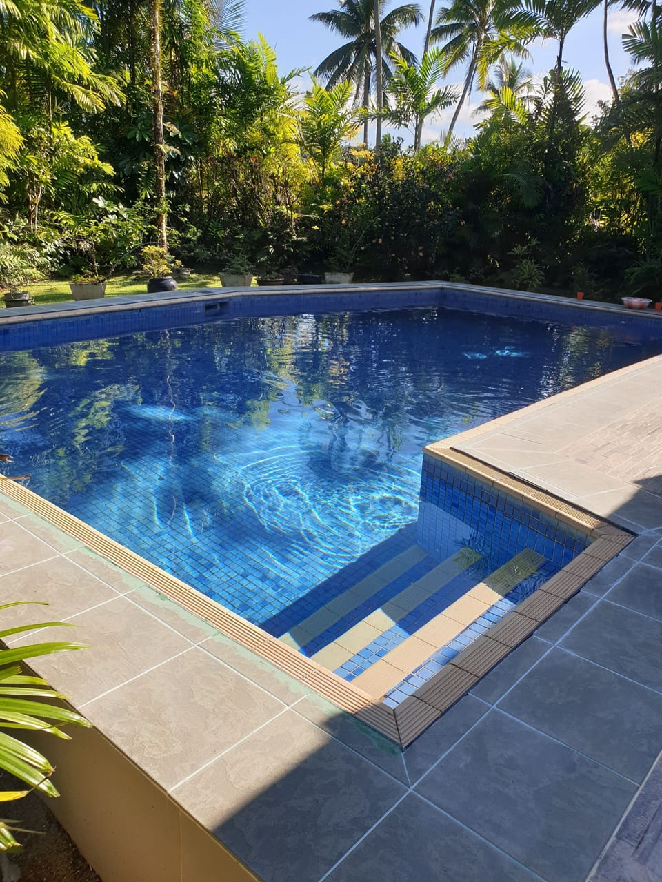 Refreshing pool in private garden area with tiled patio