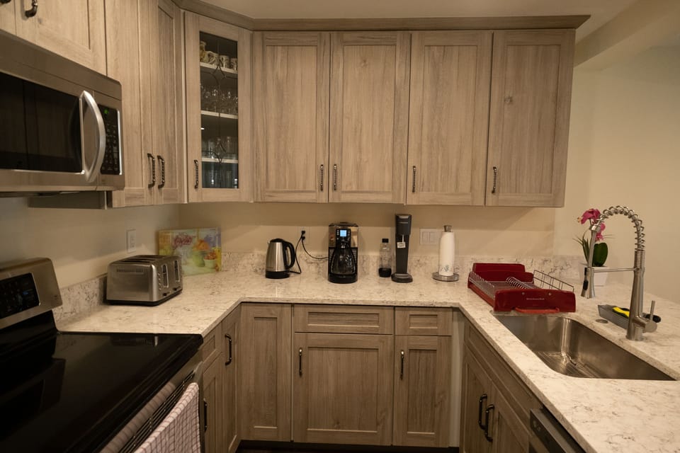 Kitchen is dressed to live in! Plenty of dishes, silverware, glasses.. 
