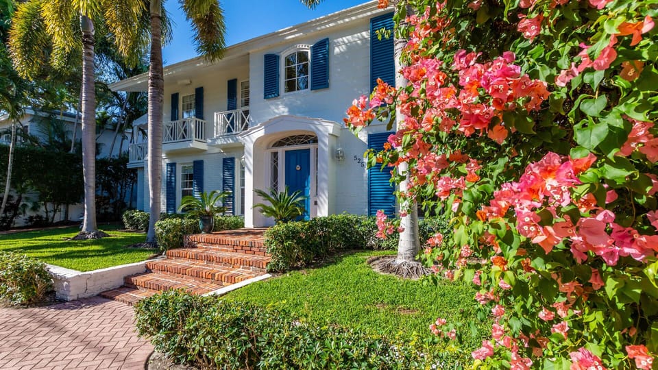 Parrot Hall is surrounded by hedges and tropical foliage for privacy and 