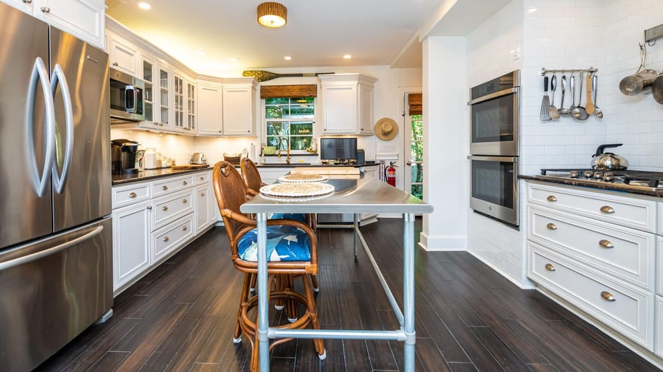 Chef's kitchen with high end finishes, gas cooktop and outside natural gas grill