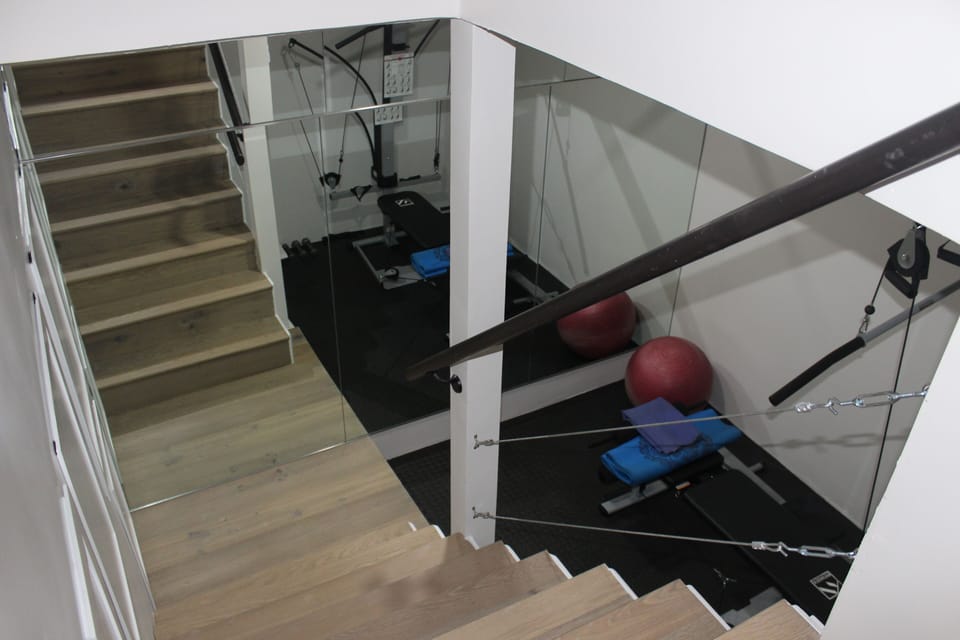 Gym equipped with "bowflex", rowing machines, yoga mats, and dumbells