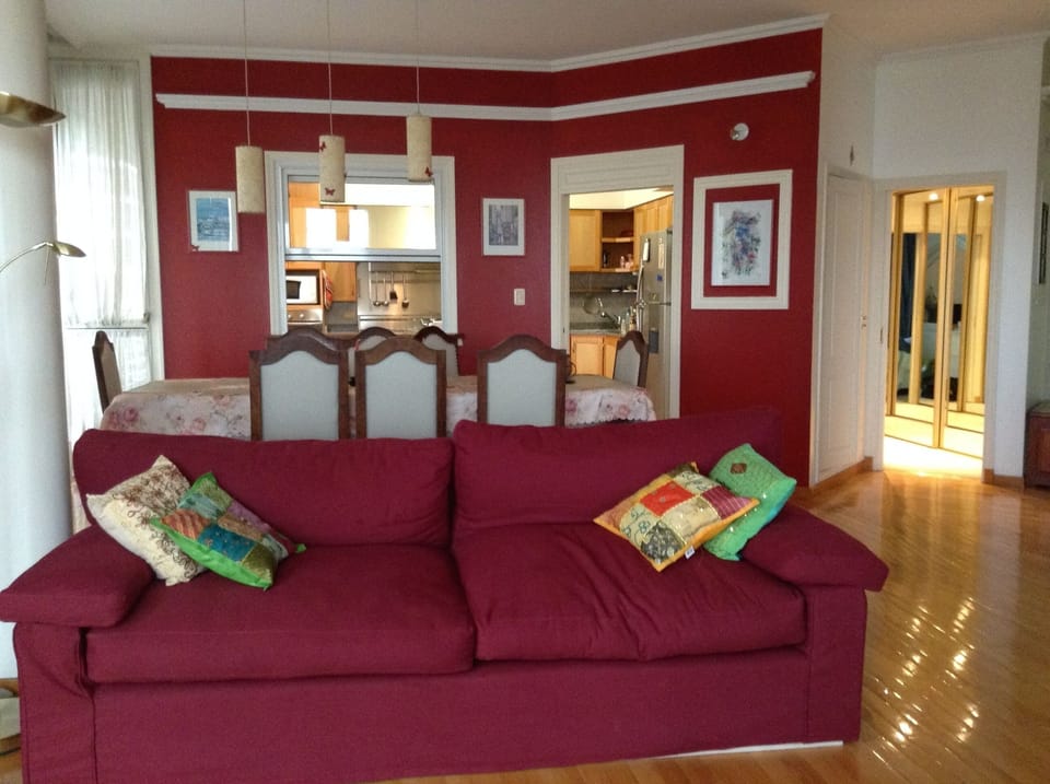Living room, dining room, and kitchen in the background.