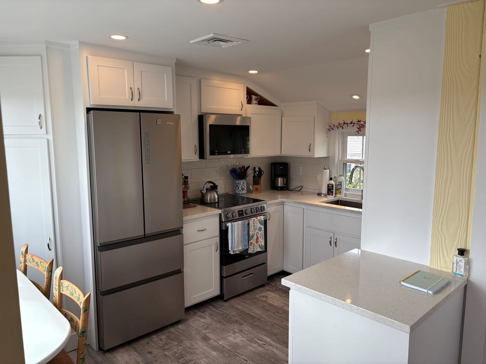 Updated kitchen with modern range, microwave oven, refrigerator and dishwasher