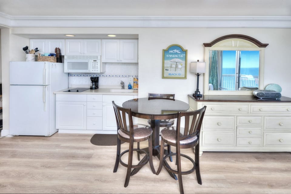 Dining table with chairs for meals in your spacious Daytona Condo Rental.