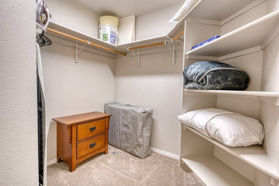 Walk-in closet in the master bedroom has plenty of space for your suitcases and travel wardrobe and comes with iron and ironing board. You will find extra blankets and pillows here as well as a single size rollaway bed and bedding. 