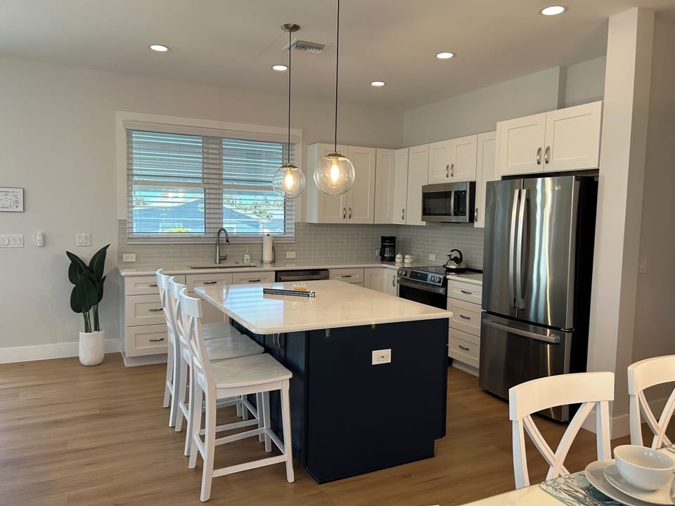 Kitchen with island and dining chairs.