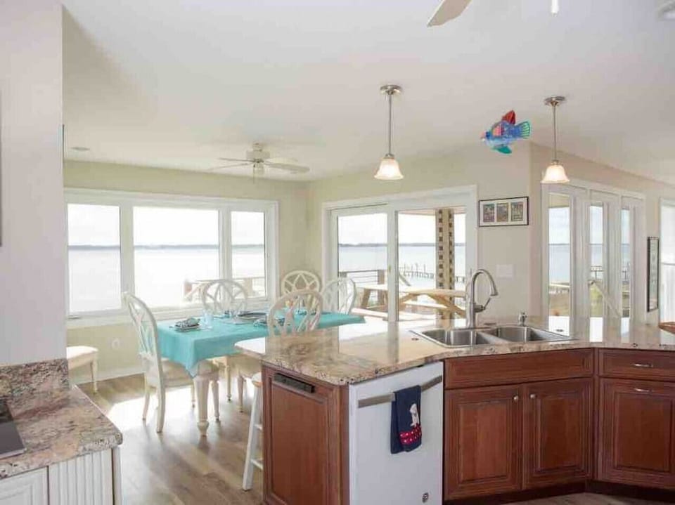 Full kitchen has view of the pier, pool, and water.