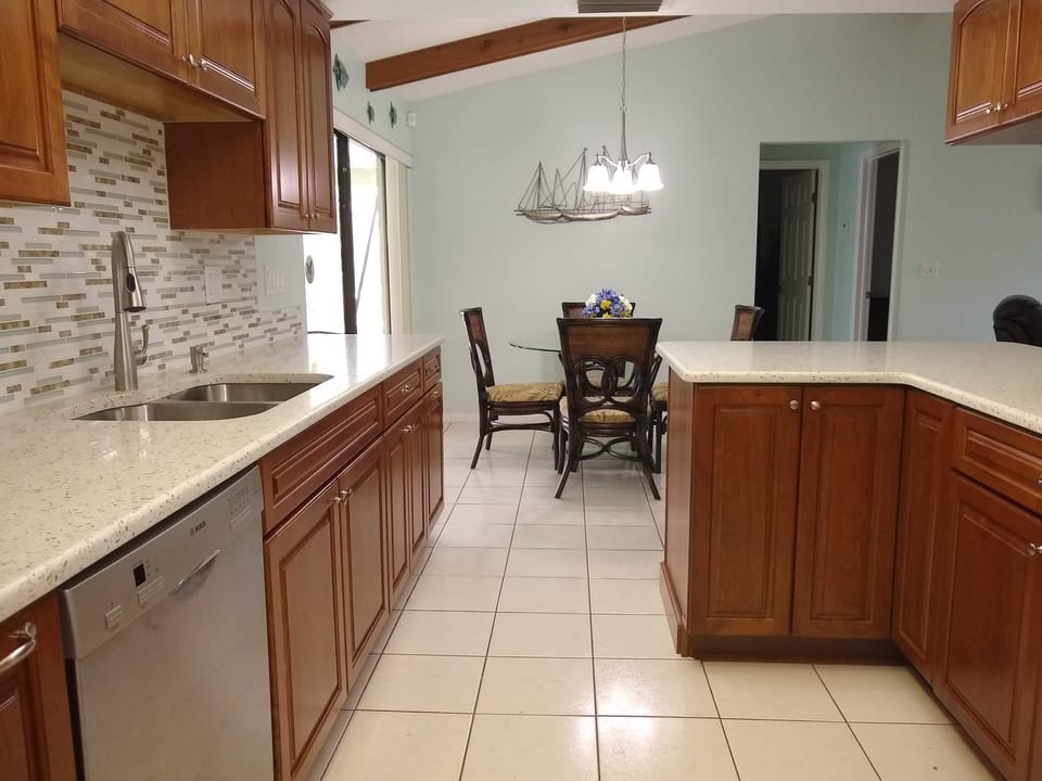 Newly updated Kitchen with seaglass Quartz counters & cherry cabinets.