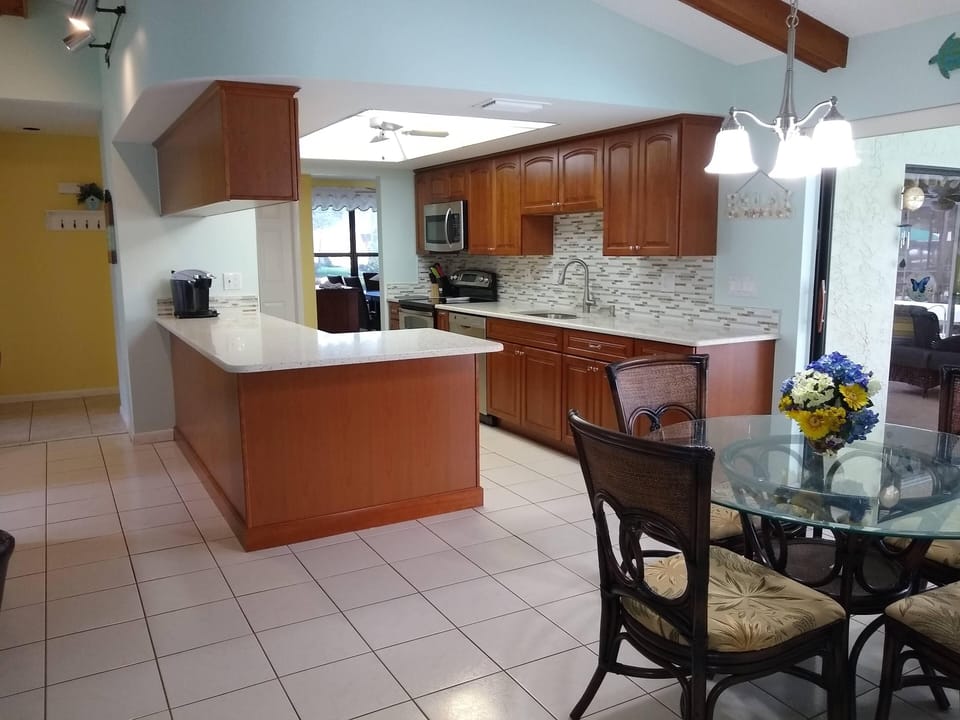 Newly updated Kitchen with seaglass Quartz counters & cherry cabinets.