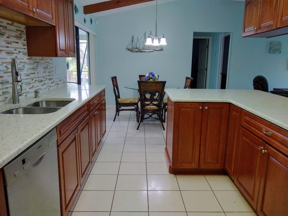 Newly updated Kitchen with seaglass Quartz counters & cherry cabinets.